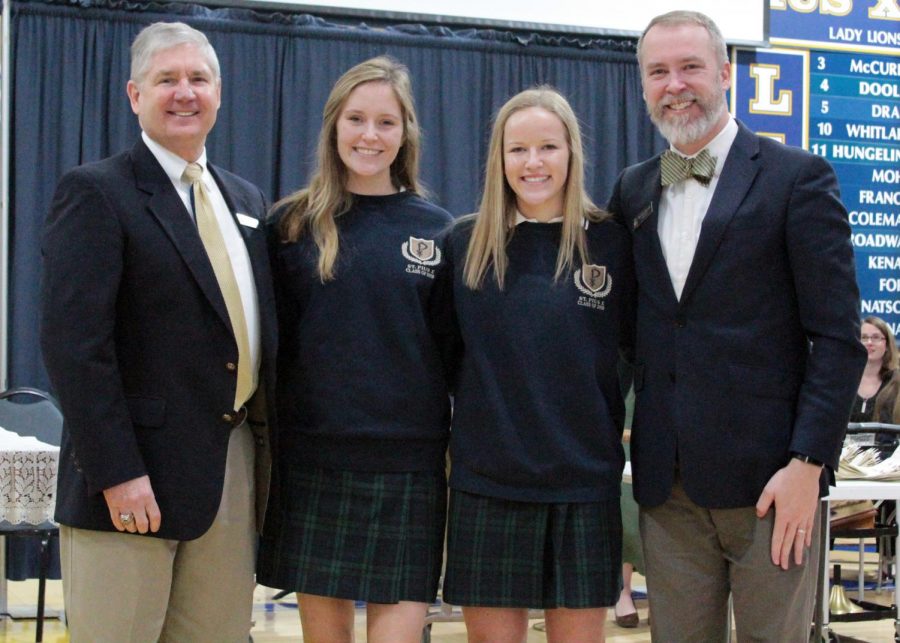 Seniors Ansley Boykin (left) and Ellie Glenn stand with Principal Steve Spellman and President Chad Barwick after an all-school mass on February. Glenn was named the Valedictorian for the Class of 2019 and Boykin the Salutatorian