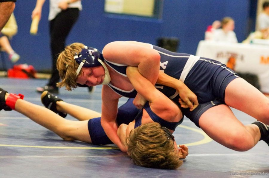 Senior Sean Laubenthal  fights to pin an opponent at a home match
