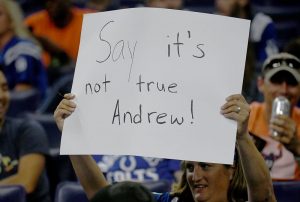 A Colts fan hold up a sign expressing her sadness  after learning that star quarterback Andrew Luck was suddenly retiring.