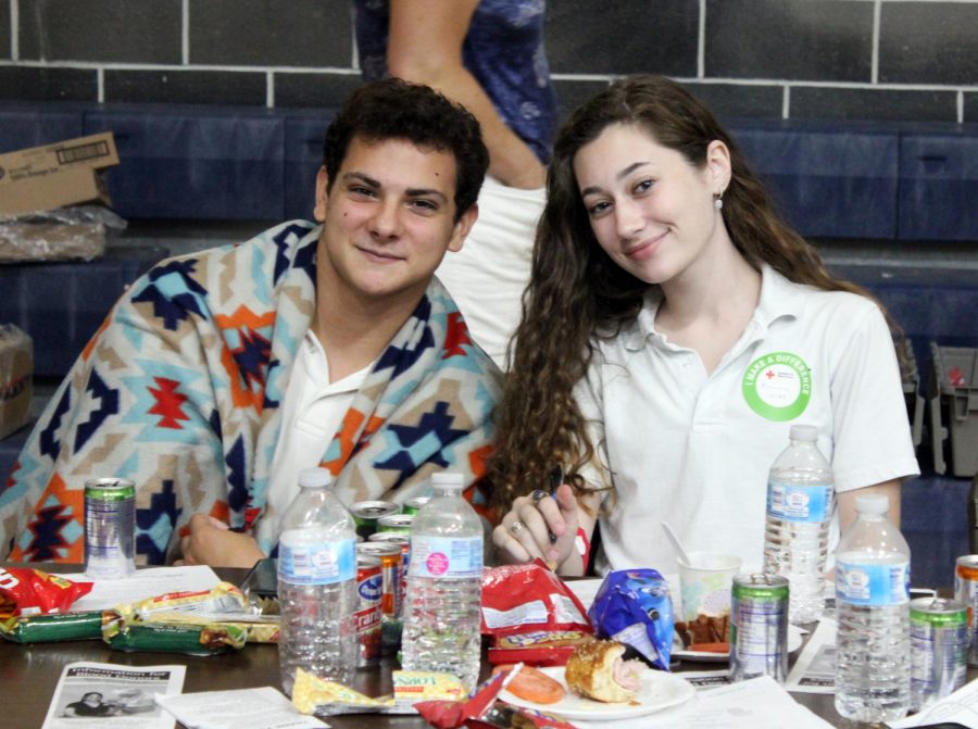 Seniors Nick Nowack and Emma Foy sit at the snack table after donating blood last spring. Their contributions helped St. Pius X earn the Blood Sponsor Group of the Year award from the American Red Cross.