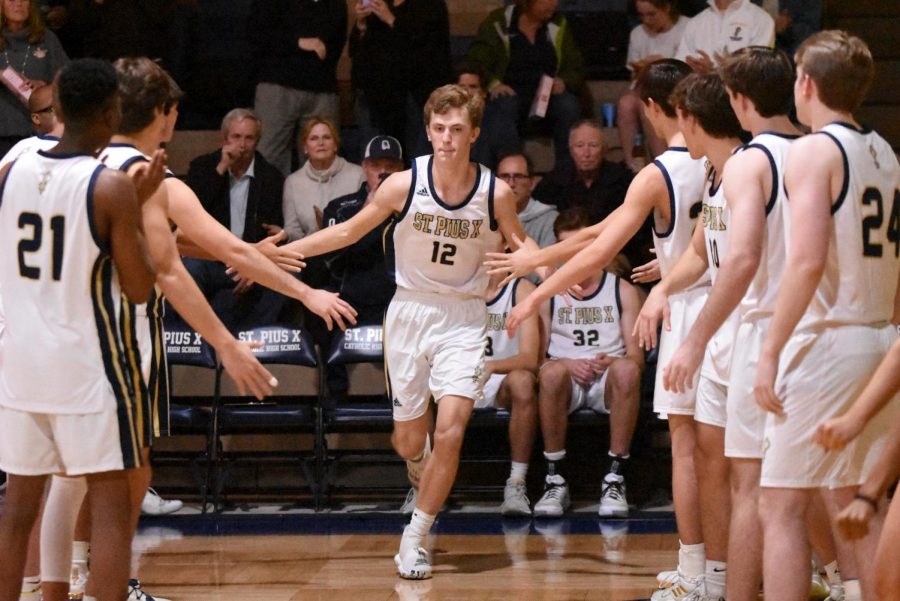 Junior Cal Petersen runs onto the court as his name is announced before a game against Lovett. Petersen has emerged as one of the top dogs on the floor this season.