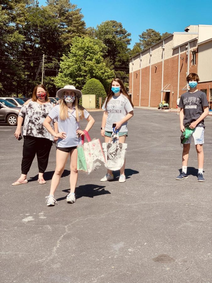 Science teacher Ms. Beam, juniors Alyssa Pulous and Maggie Bridges, and freshman Ben Bridges practice social distancing while on campus for locker clan out  on Friday, May 1. 