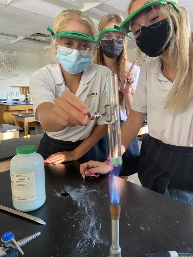 Sophomores Julia Tiberia, Nora Tolbert, and Hadley Broughton participate in a science lab during chemistry class. Most students prefer in-person learning over virtual learning because it allows them to interact with their classmates and teachers in a more engaging way.