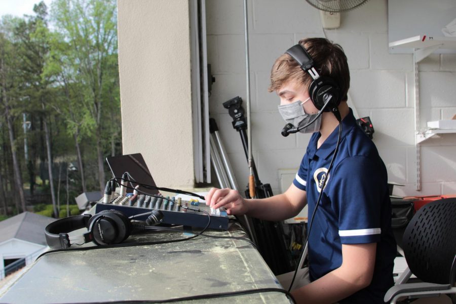 Sophomore Tripp Buhler sets up his equipment in the press box before a varsity lacrosse game in March. Buhler and his ESPX crew also broadcast football, basketball, and soccer games.
