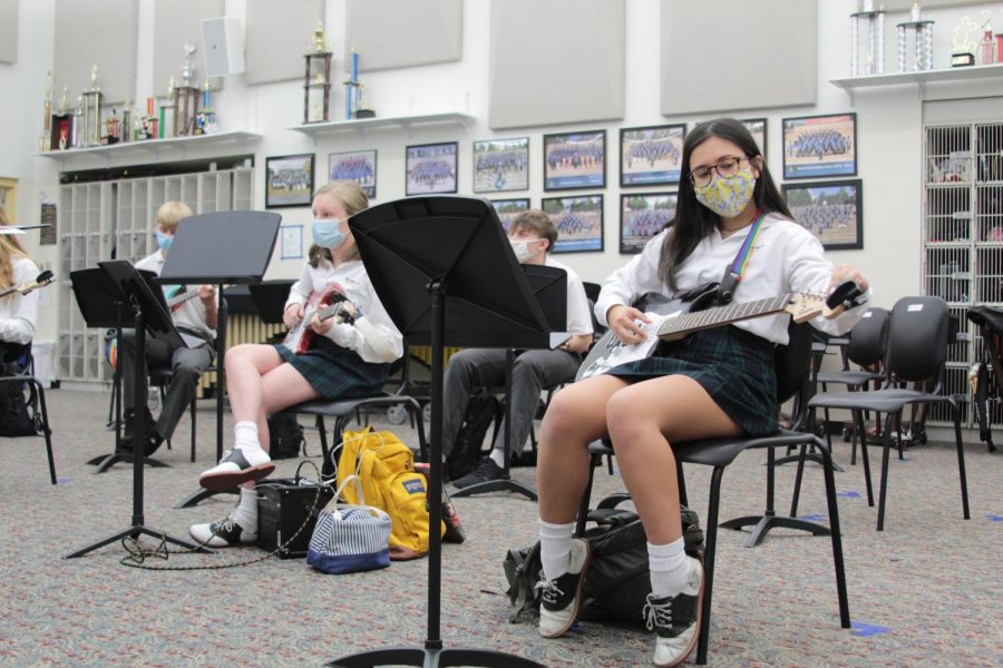 Sophomore Gaby Franco tunes her guitar at the beginning of class in March. Franco along with sophomore group members Lily Stokes and Hannah Hungeling wrote and recorded an original song titled After Him based loosely on the movie After.