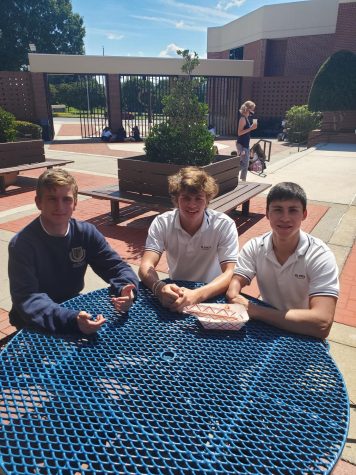 Seniors Sutter Guttery, Joseph McGhee, and Gabe Velaz share a basket of fries during 5th period lunch.