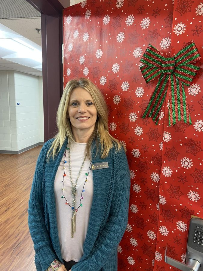 Mrs. Blackburn shows off festively decorated classroom door.