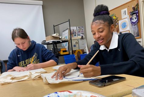 Members of the Fashion Club paint canvas tote bags in the art room at one of their meetings in November.