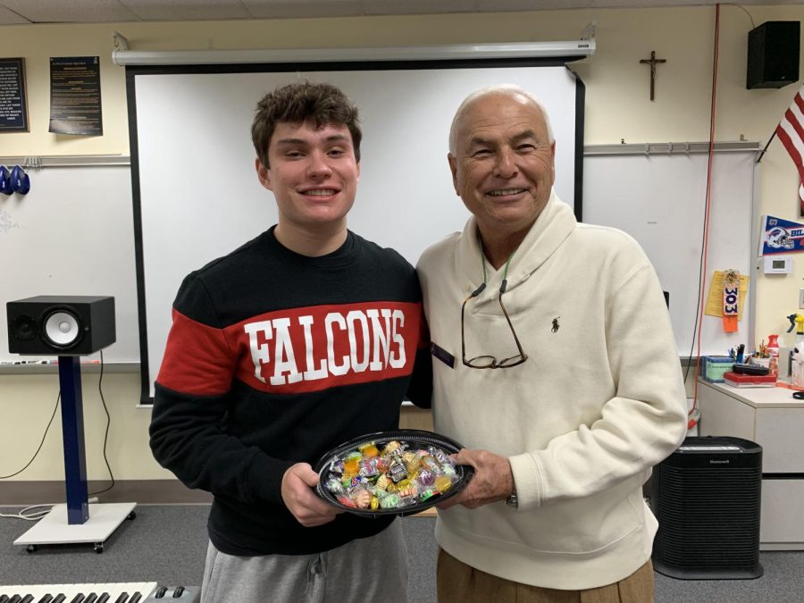 Senior+Rain+Mason+enjoys+a+treat+from+Mr.+Smiths+famous+bowl+of+candy.+A+former+English+teacher+at+St.+Pius+X%2C+Mr.+Smith+is+now+students+favorite+substitute+teacher.