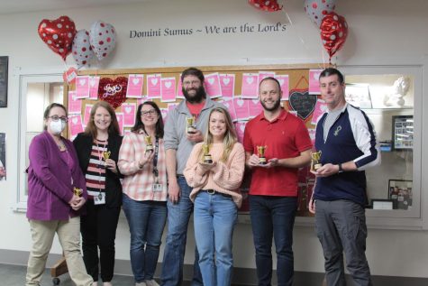 Teachers smile with their trophies after winning a Golden Tassel Award in February.