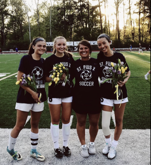 Maggie Green (second from left) celebrates Senior Night in 2019 when she was a member of the soccer program. Head coach Sara Schmitt invited her to speak to the girls soccer program about the importance of proper nutrition.