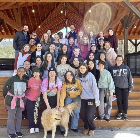 Students and faculty chaperones gather on the steps of Camp Twin Lakes at the girls retreat in March. 