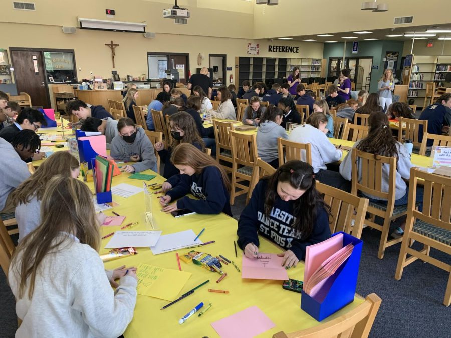 Juniors complete a service project in the library during their class pilgrimage on March 3.