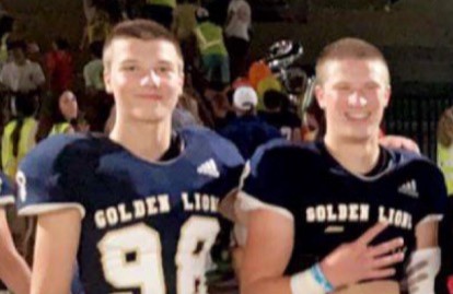 Sophomores Asher Chenault (left) and Carter Kandilakis show off their shaved heads after a varsity football game early in the season.