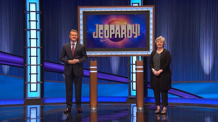 Mrs. Marsha Free stands on the Jeopardy! set with host Ken Jennings. She taped her show in August, and it will air Tuesday, October 11 at 7:30 pm.