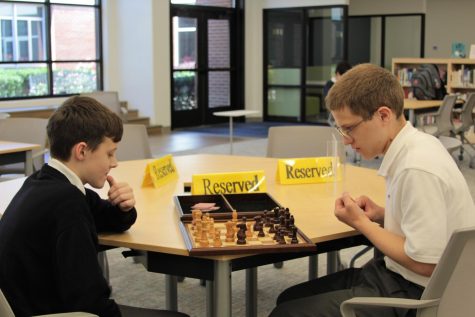 Freshman Matthew Dulaney and junior Randy Graebner compete in a tense chess match in the library. The game has taken off in popularity at school this year.
