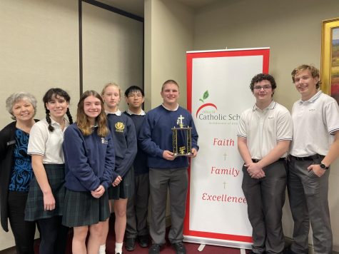 St. Pius X won the Archdiocese of Atlanta annual Theology Bowl on March 1. They competed against Catholic high schools across Atlanta, and this was their second championship in three years. From left to right: Mrs. Marsha Free, senior Elle Smith, sophomore Abigail Gregory, seniors Lily Perella and John Nguyen, junior Will McBride, and seniors Rollen Williamson and Brian Knuth.