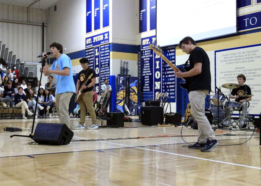 Sophomores Patrick Davey (lead singer), Luke Pinson (bass), Rory Stokes (drums), and senior Jack Galvez (guitar) perform at the Fine Arts Assmebly in March. 
