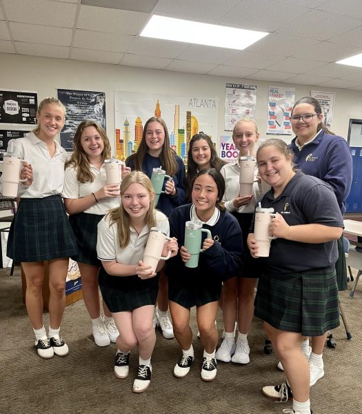 The newspaper staff shows off the new Stanleys they received from Mr. Matt Navarro 94, the Senior Vice President of Global Sales for Stanley.