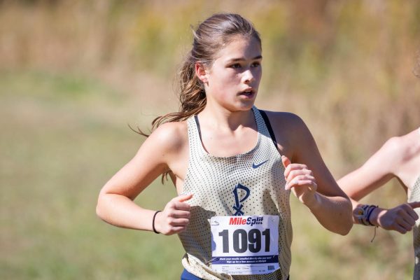 Senior Zoe Garcia races in a cross country meet in October. At the state championship race in November, she finished first for St. Pius X and helped the team place 2nd overall. Photo courtesy of Art of Life.