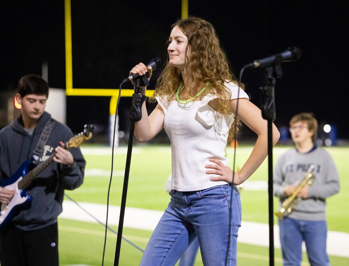 Senior Lauren Smith sings at the Senior Night football game. Traditionally on Senior Night, the marching band performs their Special Show during halftime. This years songs included Shake It Off, All of the Lights, and Bad Romance. © 2023 Art of Life Photography