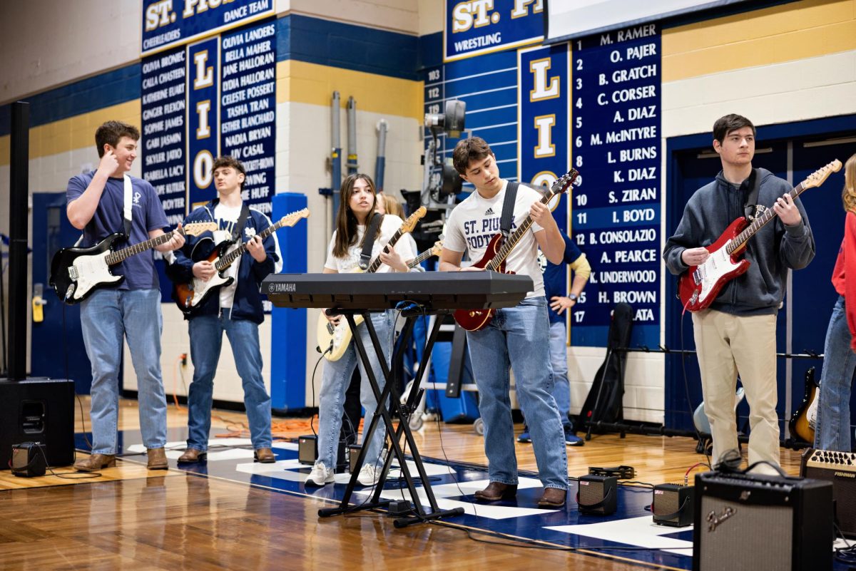 Guitar students perform at the annual Fine Arts Assembly on March 3.