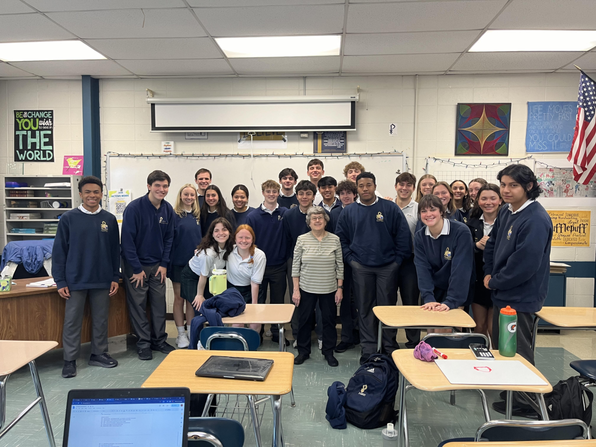 Juniors and seniors in Analaysis get together for a picture with Mrs. Rummel on her last day as their long-term sub. Courtesy of Madeline Randa