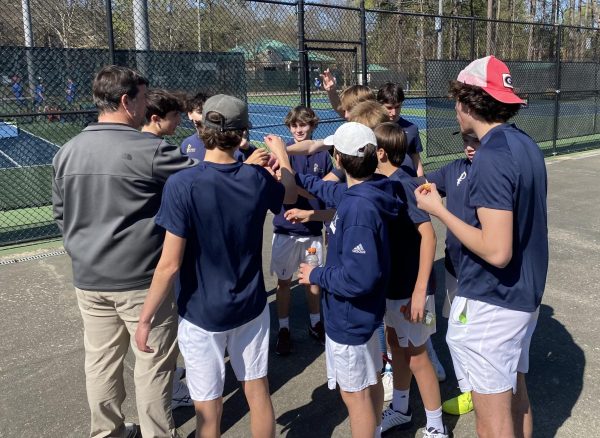 Mr. Murphy huddles together with the team before a match against Riverwood in March.