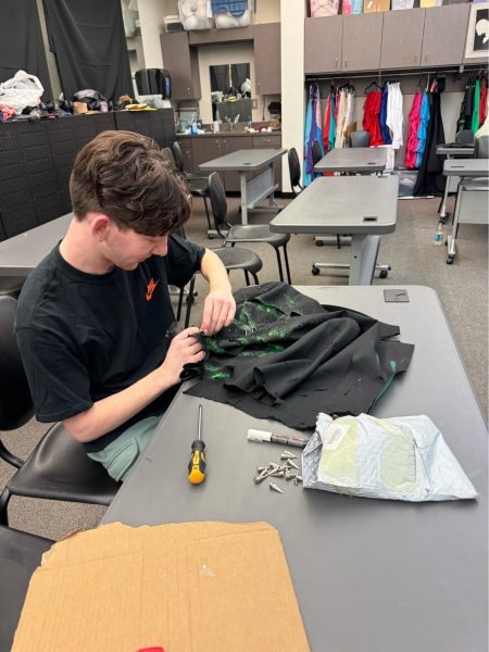 Junior George Lesinski works on making a costume for the spring musical, The Little Mermaid. Lesinski made all of the shows costumes, and he plans to pursue a fashion career in college.