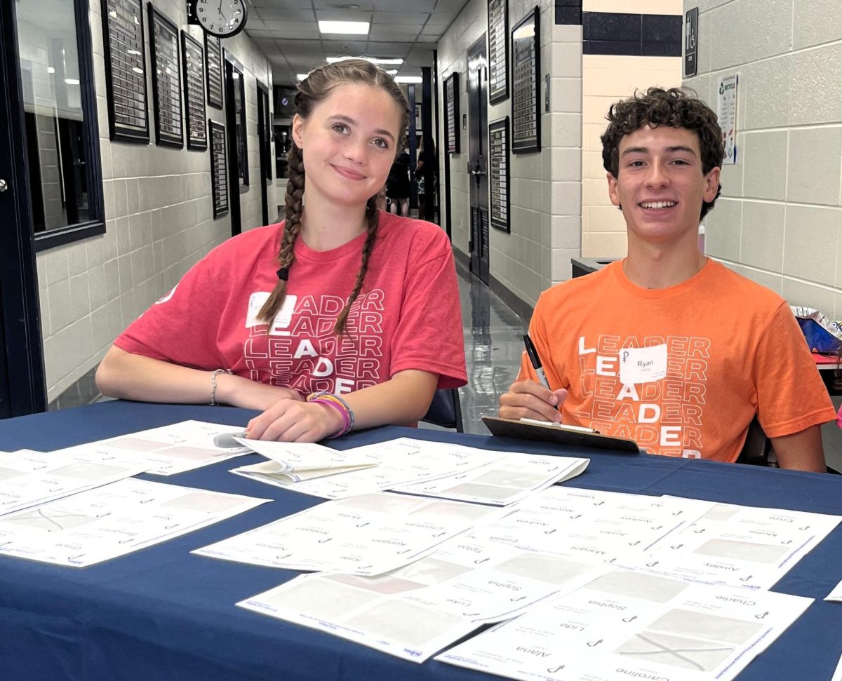 Junior AnnMarie Sawyer and senior Ryan Lathrop help check-in freshmen at Camp Golden Lion.