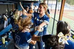 Junior Maggi Laba celebrates with her teammates in the dugout on Senior Night. The Golden Lions defeated Southwest Dakalb 15-2.