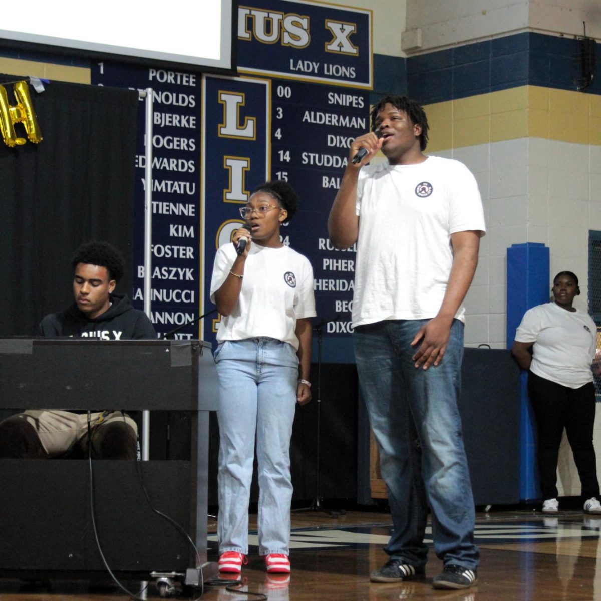Seniors Ravi Luster, Noa Rollins, and Dimeji Adekeye, all members of the Diverse Student Union, perform at the Black History Month Assembly in February 2025. 
