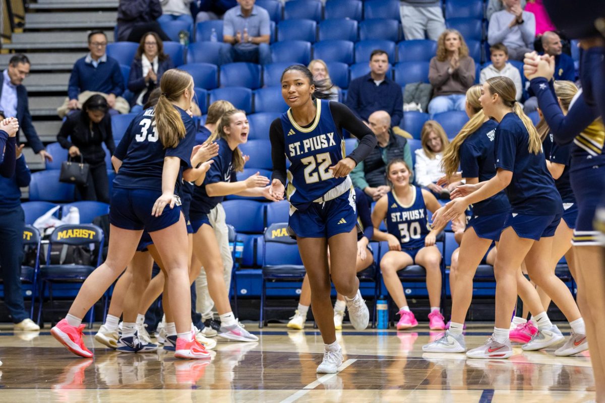 Senior Parker Lee runs onto the court during pre-game introductions before a matchup against Marist in December.
