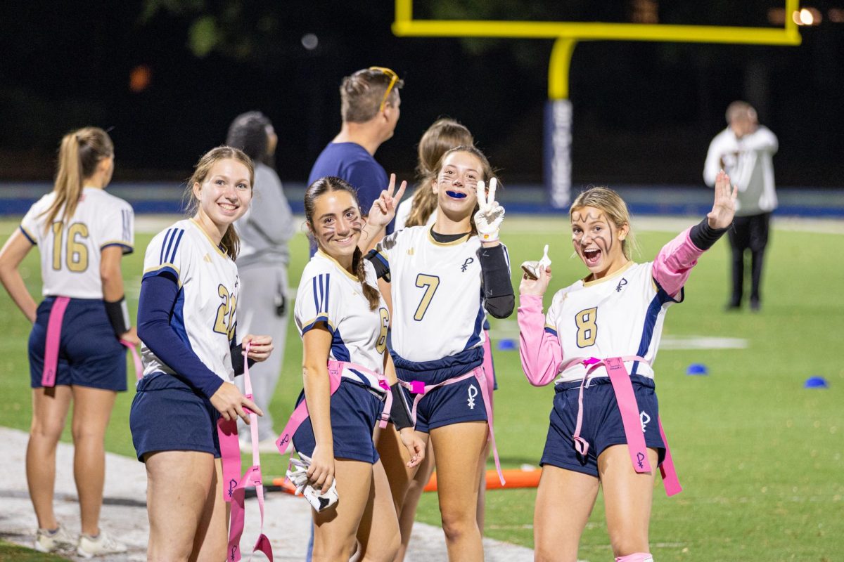 Members of the varsity flag football team show their team spirit on the sideline during a game against Riverwood in October, which they won 34-0.