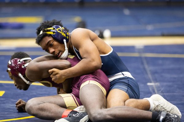 Senior Meco Favors wrestles an opponent from Tucker at a match in December.