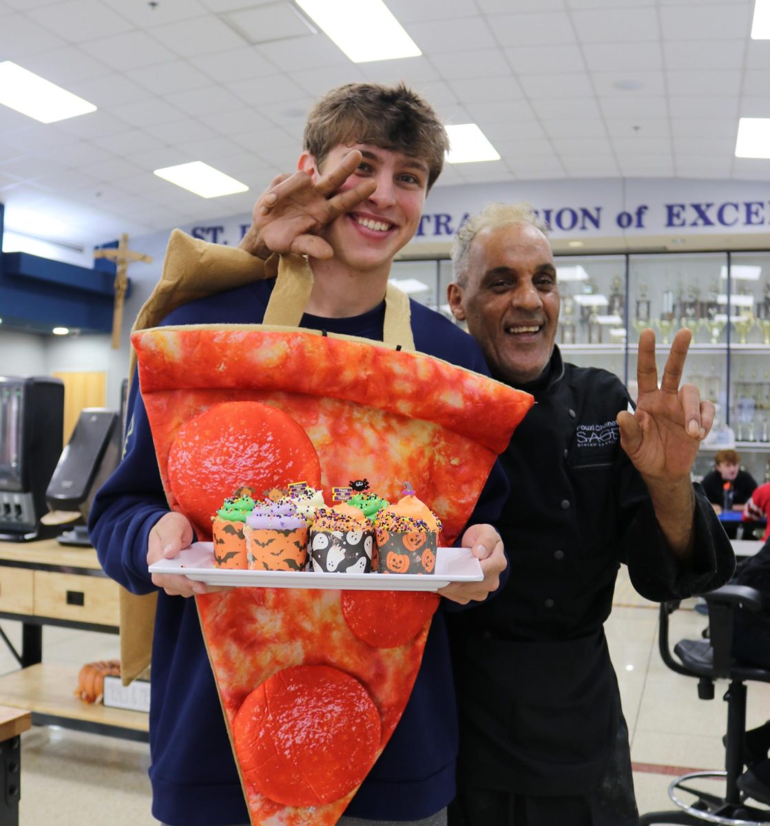Senior Andrew Kazmer and a Sage employee have fun while taking a photo on Halloween.
