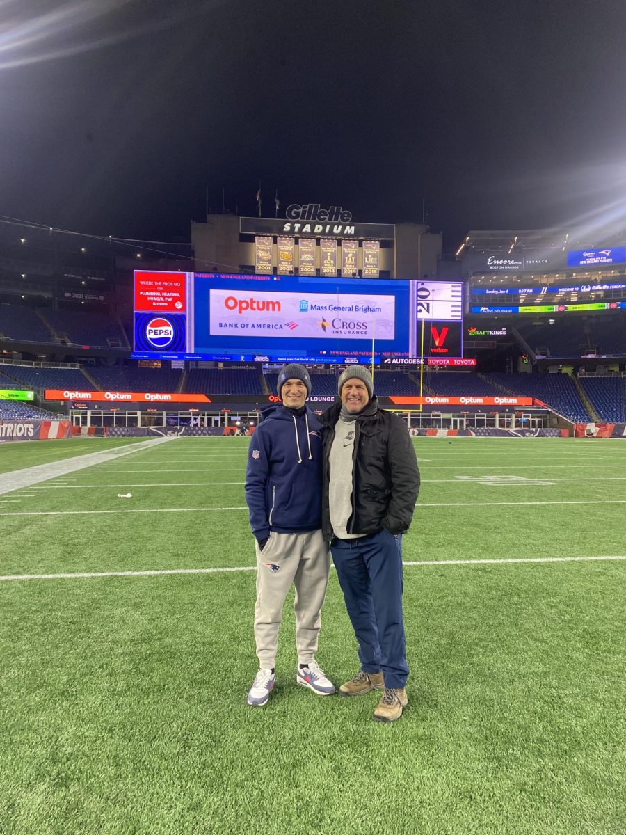 Stephen Jacon takes a picture with SPX athletic trainer Schmitty after a New England Patriots game this winter. Jacon serves as an athletic trainer for the Patriots. Photo courtesy of Schmitty.